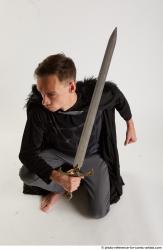 Man Adult Athletic White Fighting with sword Kneeling poses Coat